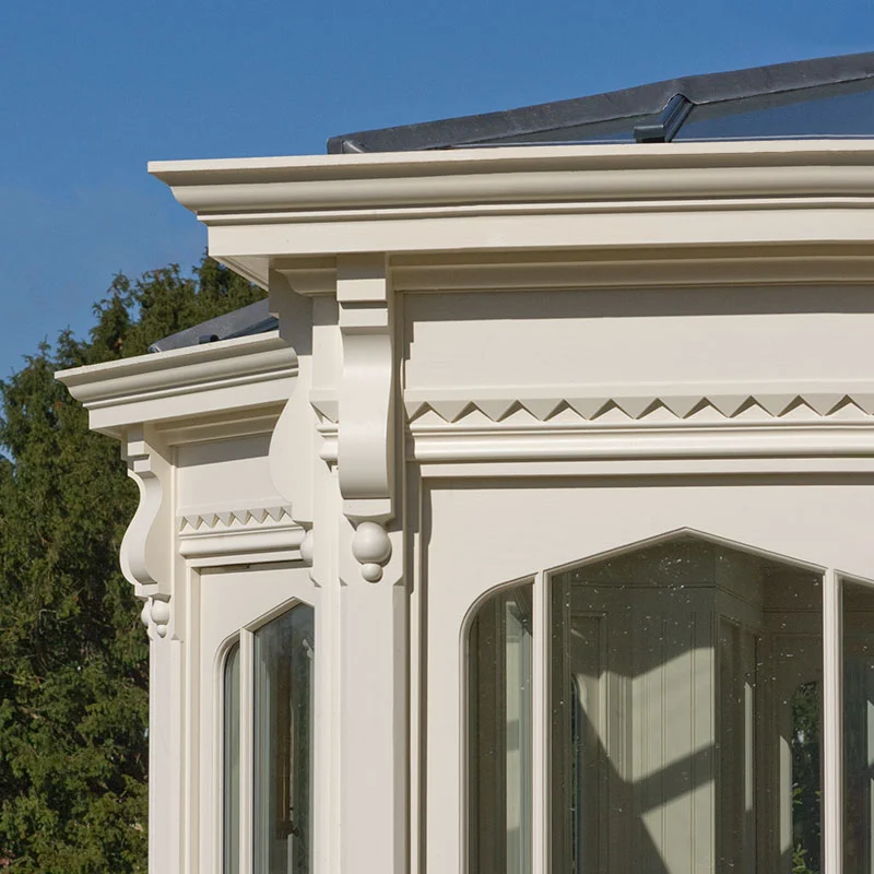 Traditional garden room with Gothic-style windows and dentil moulding