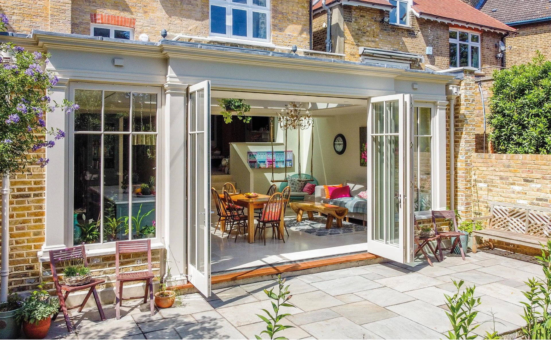 View of London townhouse orangery with bifold doors open